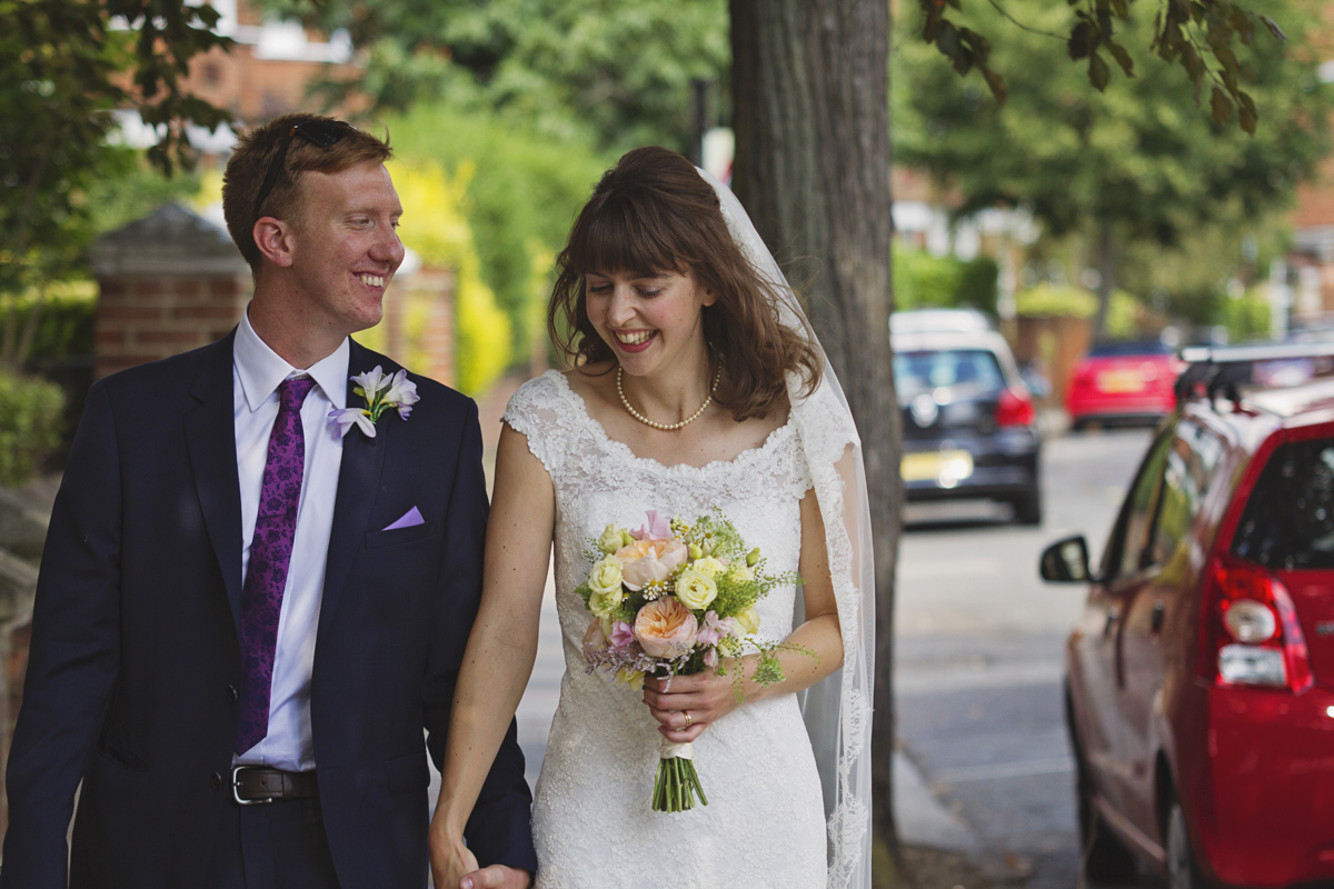 Newlyweds walking down a street laughing