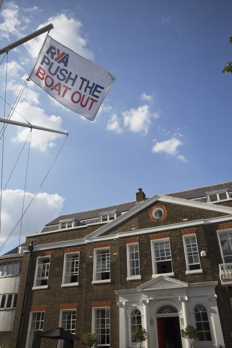 A shot of Linden House in London with a flag in foreground saying 'Push the Boat Out'