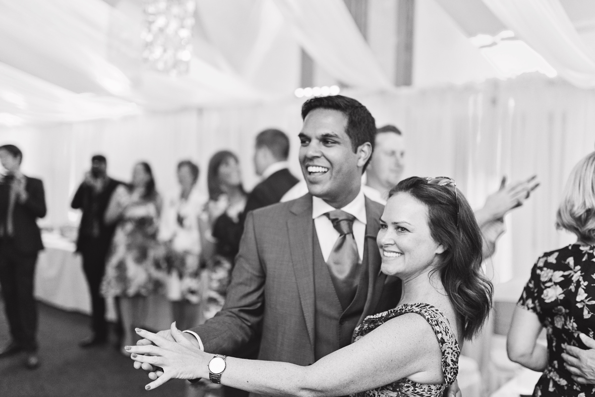 Two wedding guests dancing together at a wedding reception