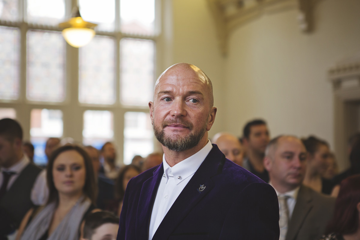 A close up shot of a Groom looking pensive at his wedding