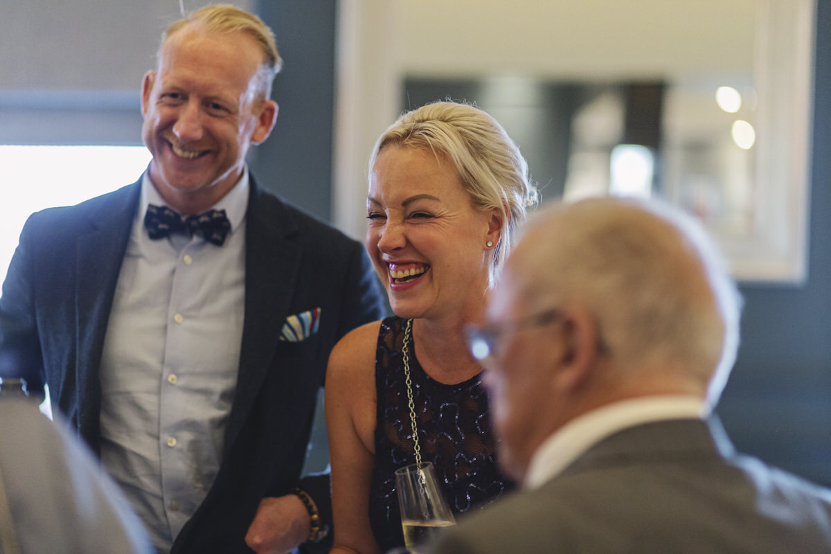 Guest laughing at the bar during a wedding reception
