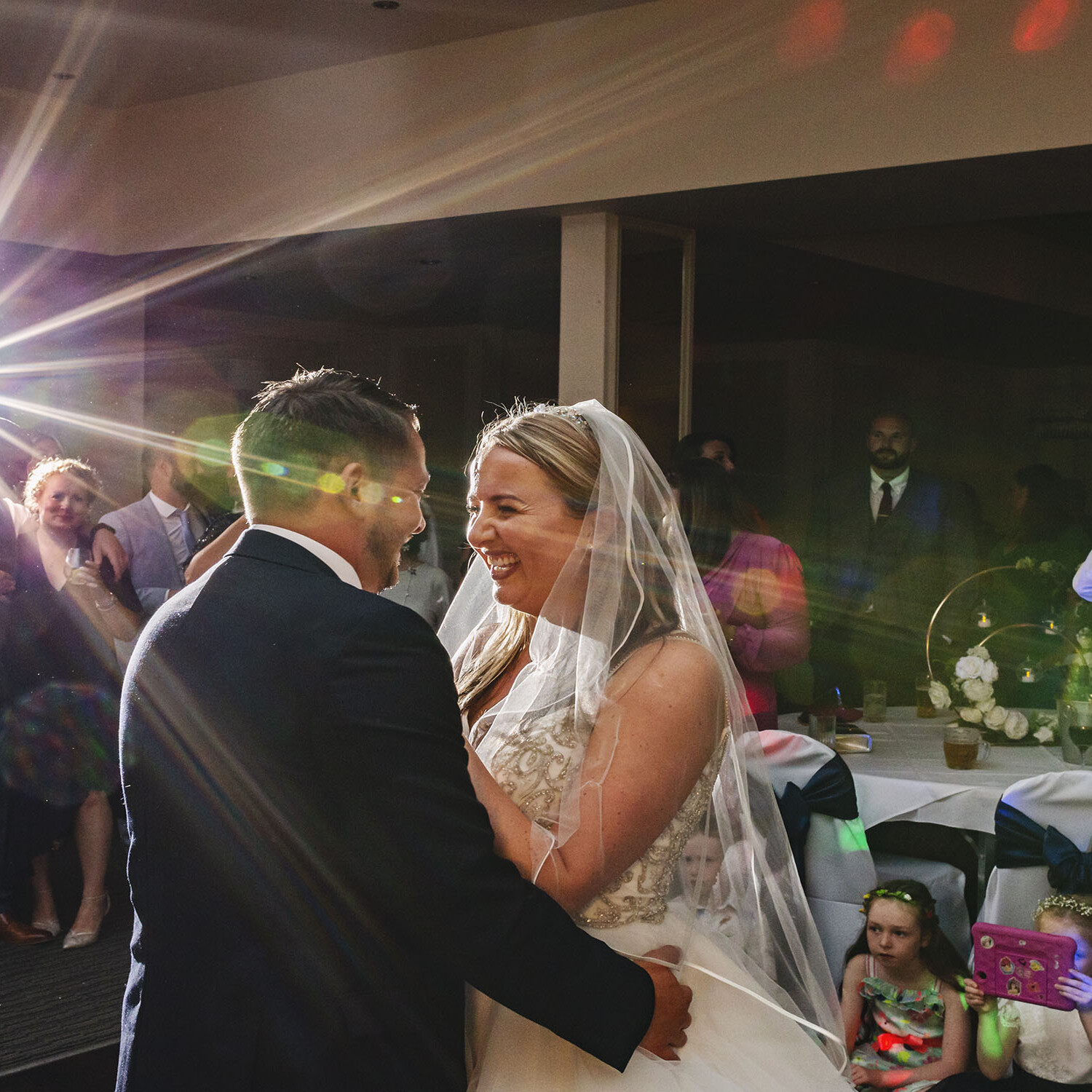 A newlywed couple enjoy their first dance as the Clifton Arms Hotel in Lytham as guests look on
