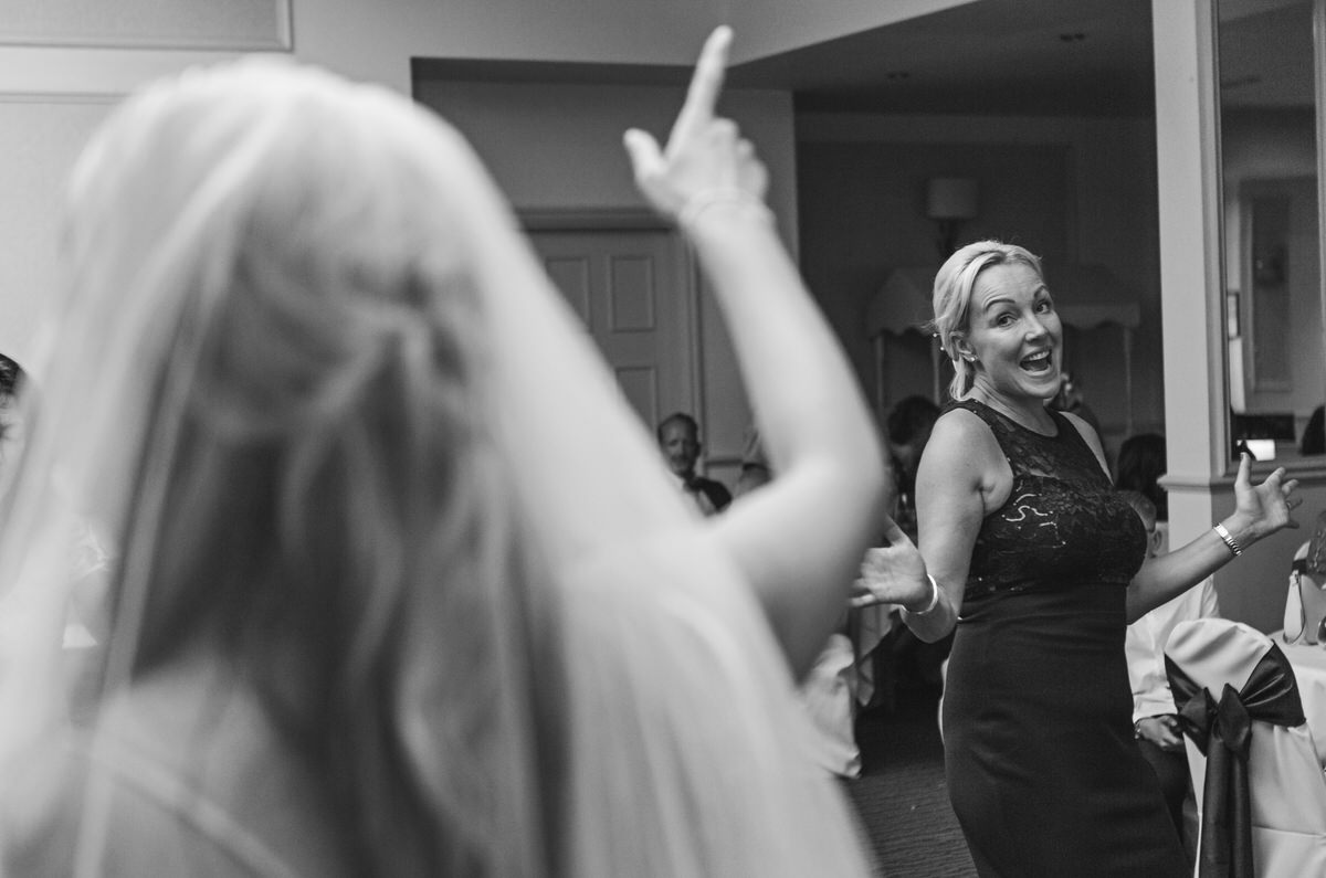 A bride dances with her sister at her wedding reception